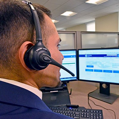 USCIS employee of Contact Center talking to customer on phone