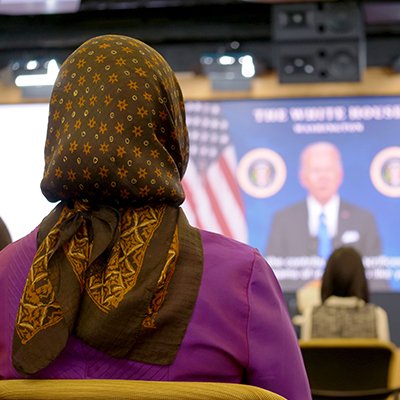 People at naturalization ceremony looking at screen