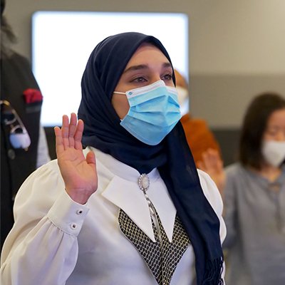 People taking the Oath of Allegiance to become citizens at USCIS headquarters