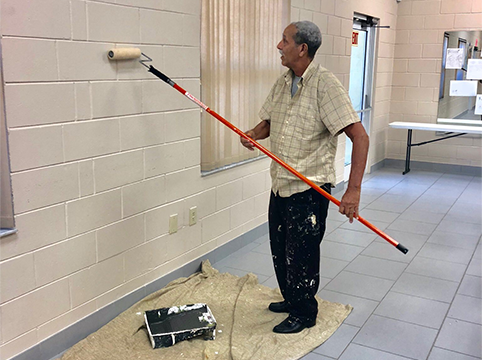 Person painting a wall